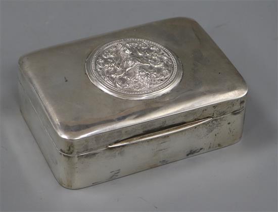 A Siamese sterling cigarette box by Alex & Co, the lid decorated with a deity, 12.4cm.